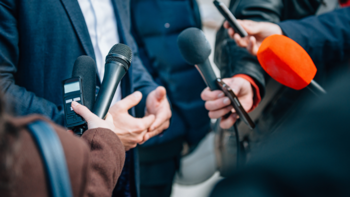 Person being interviewed by journalists