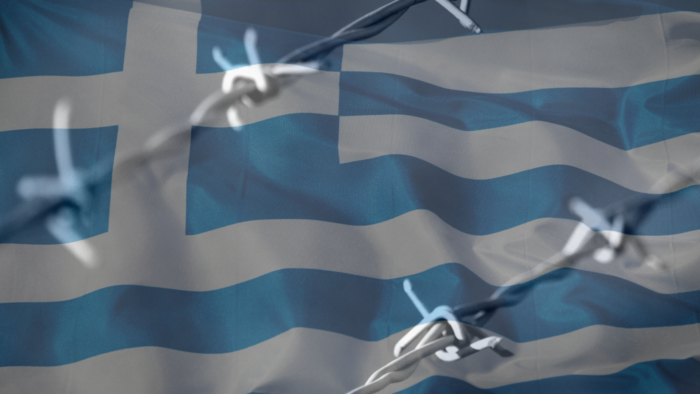 Greek flag with barbed wire in front